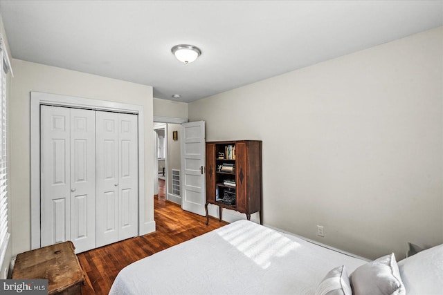 bedroom featuring dark hardwood / wood-style flooring and a closet