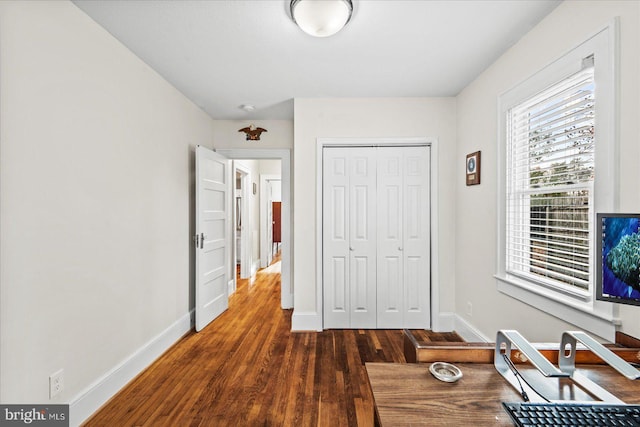 unfurnished office with dark wood-type flooring