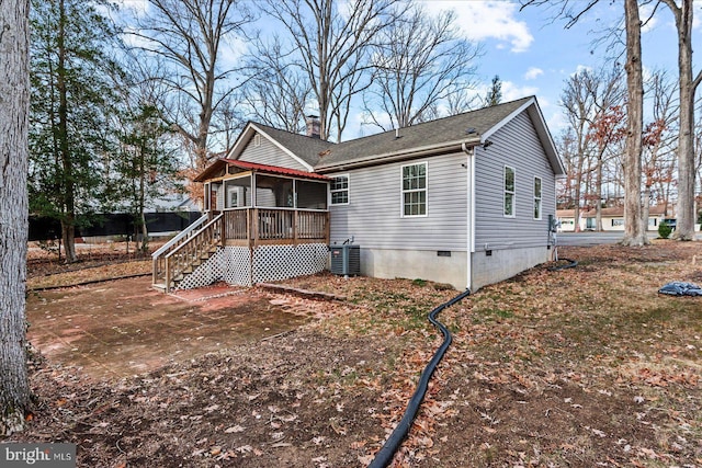 back of property with a sunroom and central air condition unit