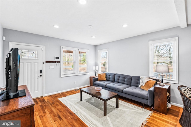 living room with beamed ceiling and wood-type flooring