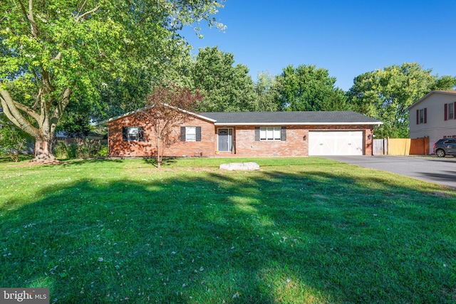 ranch-style home featuring a garage and a front lawn