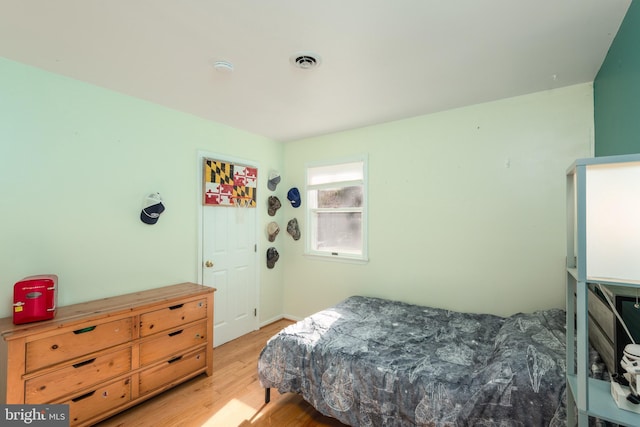 bedroom featuring light wood-style flooring and visible vents