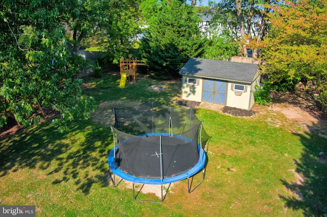 view of yard featuring a shed and a trampoline