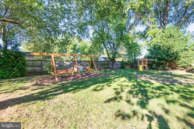 view of yard featuring a playground and a fenced backyard