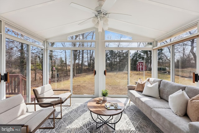 sunroom with a healthy amount of sunlight, vaulted ceiling, and a ceiling fan