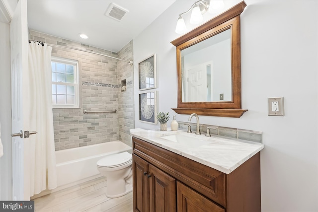 bathroom with toilet, shower / bath combo, vanity, and visible vents