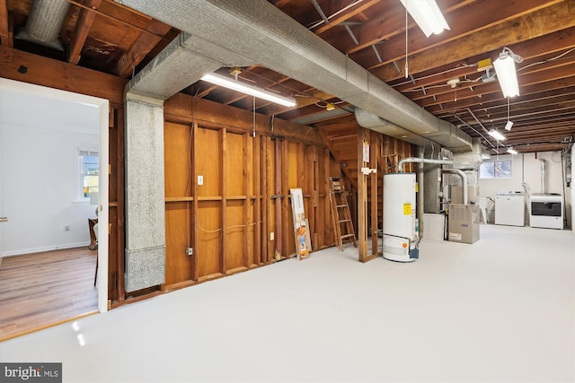 basement featuring gas water heater and washing machine and clothes dryer