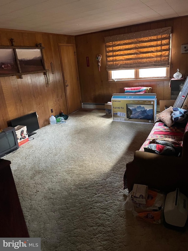 carpeted living room featuring wooden walls and a baseboard radiator