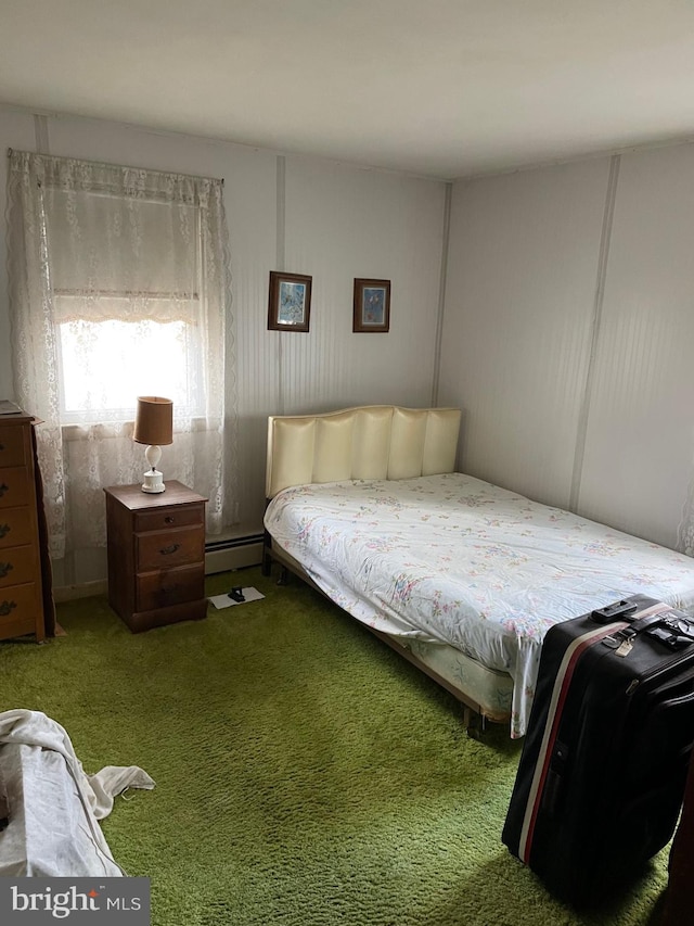 bedroom featuring carpet and a baseboard heating unit