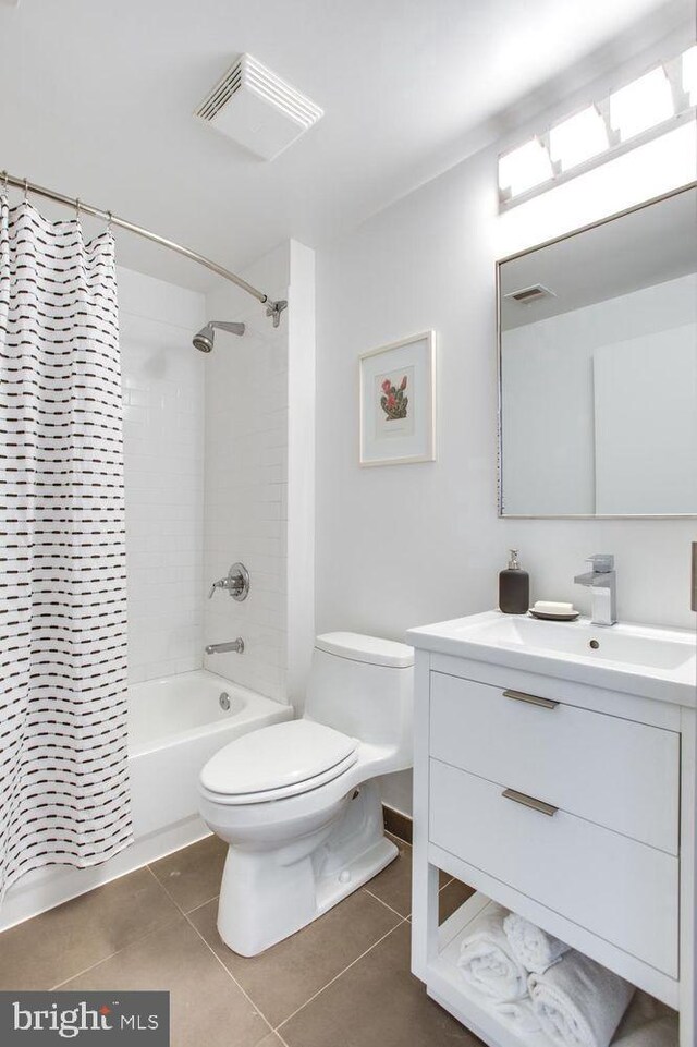 full bathroom featuring tile patterned floors, shower / bath combination with curtain, toilet, and vanity