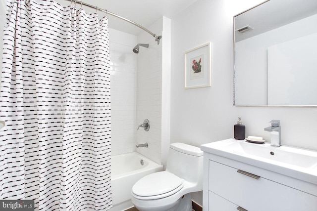 full bathroom with shower / tub combo with curtain, vanity, and toilet