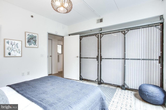 bedroom with hardwood / wood-style flooring