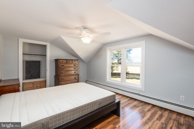 bedroom with hardwood / wood-style floors, vaulted ceiling, ceiling fan, and a baseboard heating unit