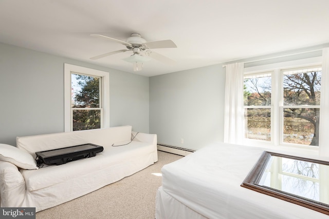 bedroom featuring baseboard heating, ceiling fan, and carpet floors