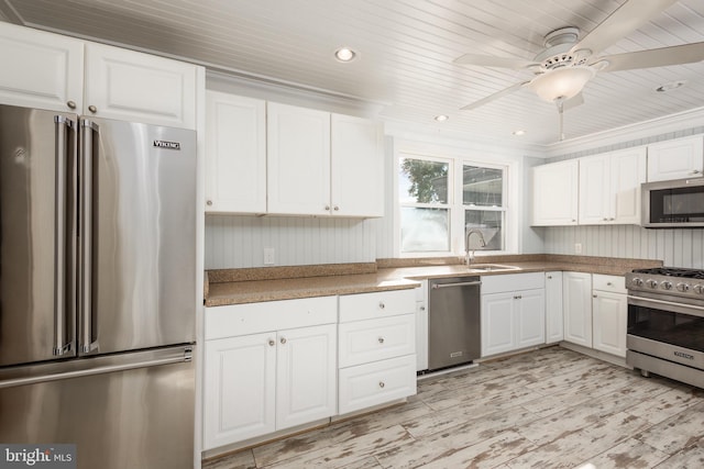 kitchen with high end appliances, ceiling fan, sink, wooden ceiling, and white cabinets