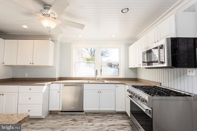 kitchen with ceiling fan, sink, stainless steel appliances, white cabinets, and wood ceiling