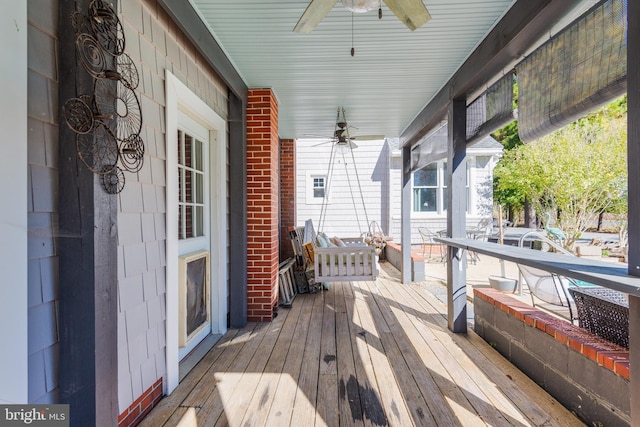 deck featuring a porch and ceiling fan