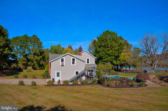 back of house featuring a lawn