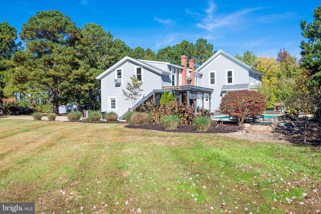 back of house featuring a lawn