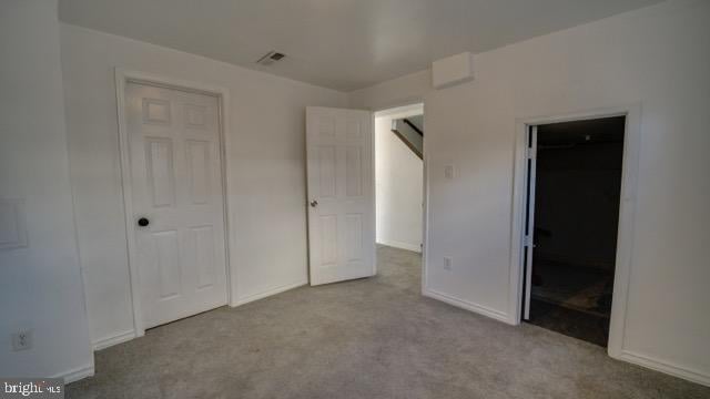 unfurnished bedroom with light carpet