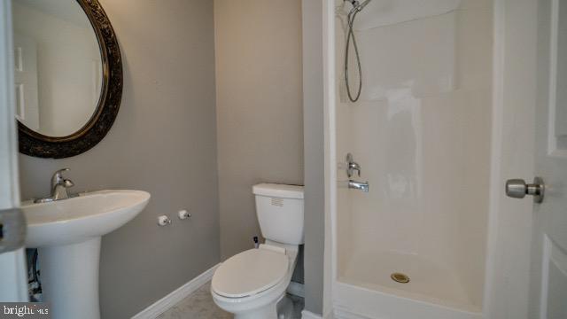 bathroom with sink, toilet, and walk in shower