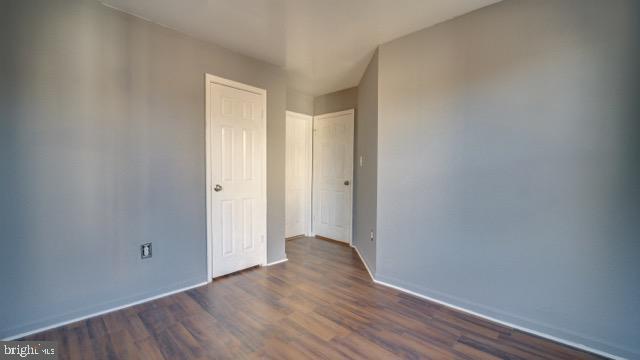 spare room with dark wood-type flooring