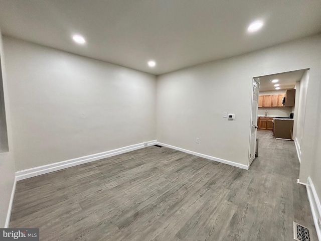 unfurnished room with hardwood / wood-style floors