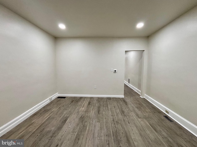 empty room with dark wood-type flooring