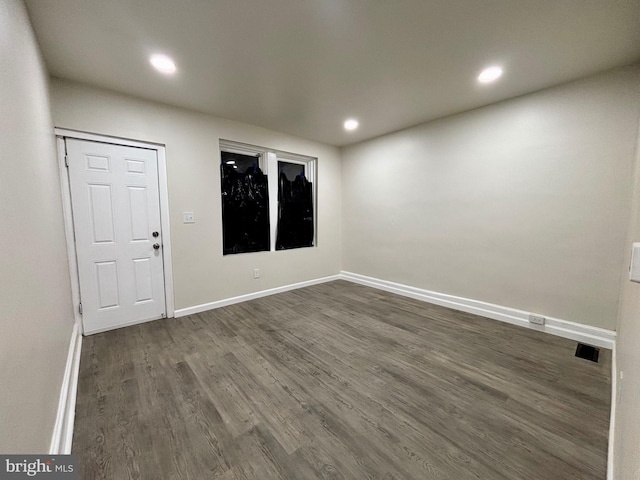 spare room with dark hardwood / wood-style flooring