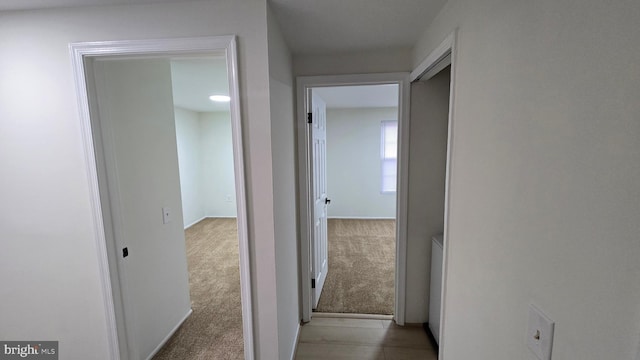 hallway featuring light carpet