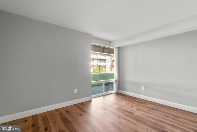 unfurnished room featuring hardwood / wood-style flooring