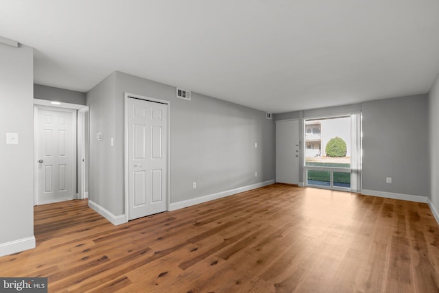 unfurnished living room featuring wood-type flooring