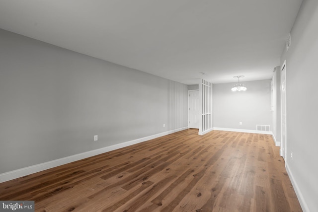 interior space with hardwood / wood-style flooring and an inviting chandelier