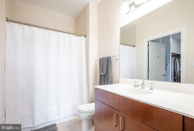 bathroom with tile patterned flooring, vanity, curtained shower, and toilet