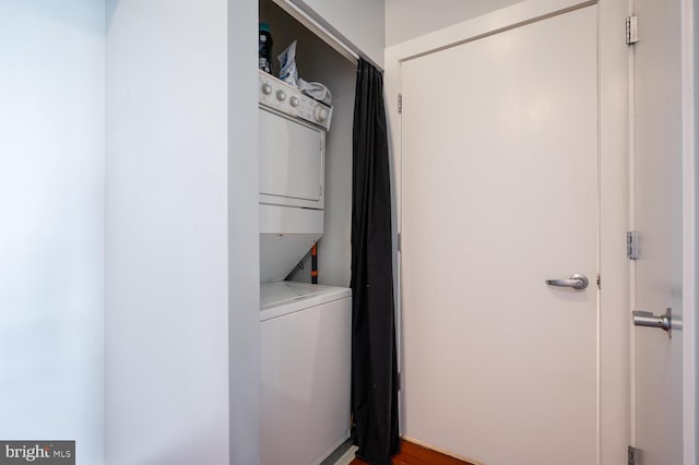 laundry area featuring stacked washer / drying machine