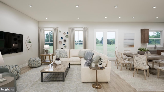 living room with light hardwood / wood-style flooring and sink