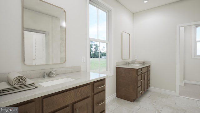 bathroom featuring vanity, tile patterned floors, and plenty of natural light