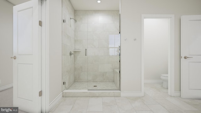 bathroom with tile patterned flooring, a shower with shower door, and toilet