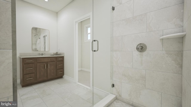 bathroom featuring vanity and a shower with door