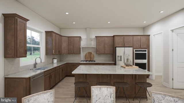 kitchen with a center island, sink, wall chimney exhaust hood, decorative backsplash, and stainless steel appliances