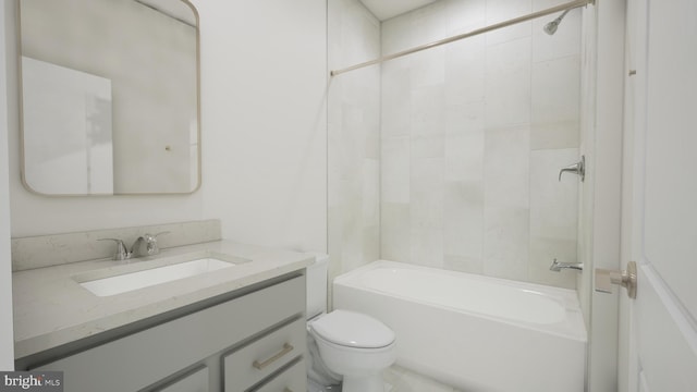 full bathroom featuring tiled shower / bath, vanity, and toilet