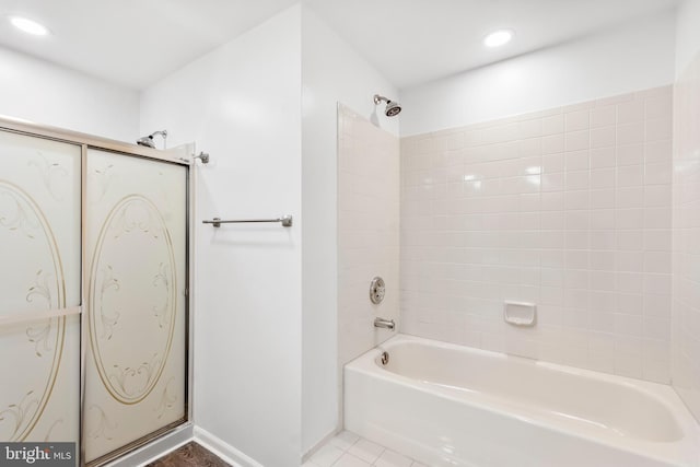 bathroom featuring tile patterned flooring and tiled shower / bath