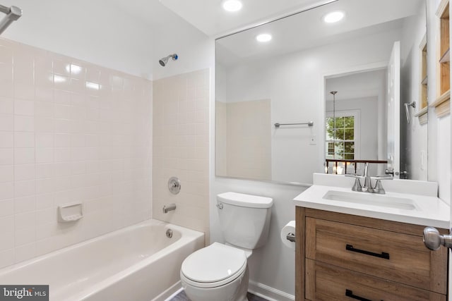 full bathroom with tiled shower / bath combo, toilet, and vanity