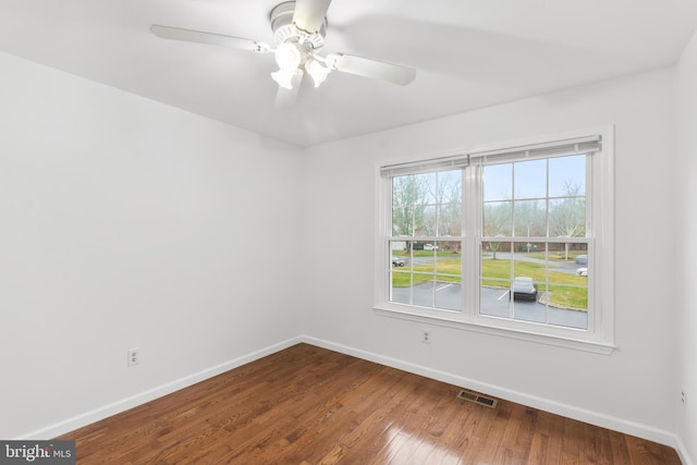 empty room with hardwood / wood-style flooring and ceiling fan