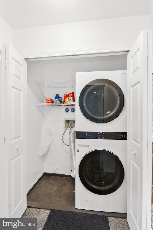 washroom featuring stacked washing maching and dryer