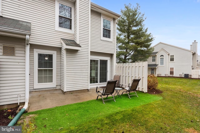 back of house with a lawn, central AC, and a patio