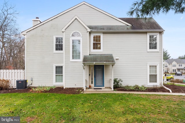 view of front property featuring central AC and a front yard