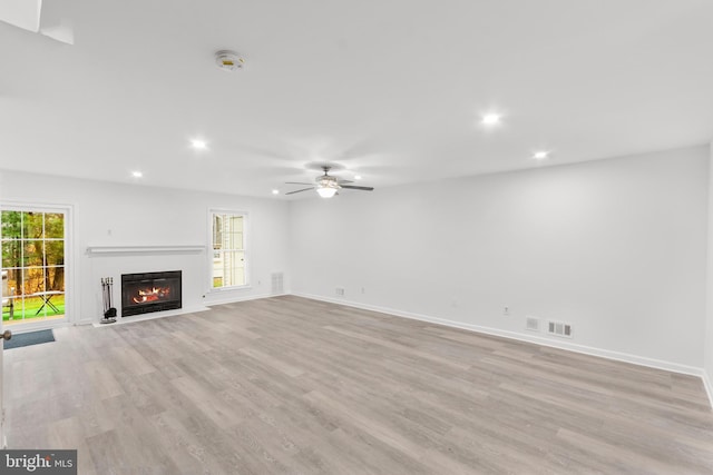 unfurnished living room with ceiling fan and light wood-type flooring