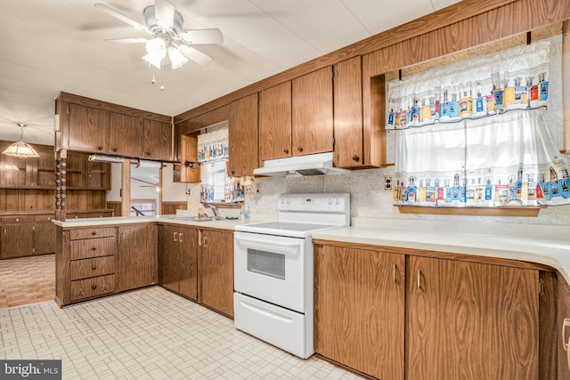 kitchen with decorative backsplash, ceiling fan, sink, decorative light fixtures, and white electric range