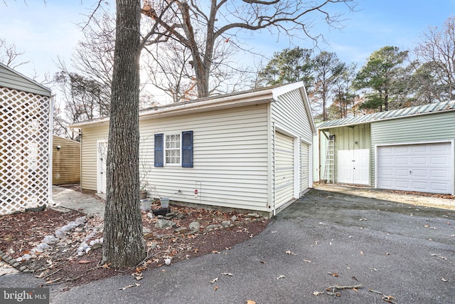 exterior space featuring a garage and an outdoor structure